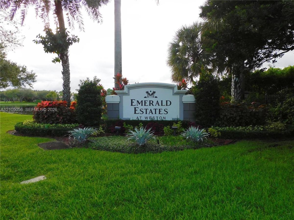 Emerald Estates at Weston signage featuring white columns and dark lettering