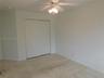 Garage space with an automatic garage door opener and two overhead fluorescent light fixtures
