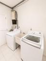 Dedicated laundry area featuring a utility sink, a top-load washing machine, a front-load dryer, and tile flooring