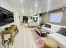 Open-concept living area with wood-finish flooring, recessed lighting, and a neutral color palette