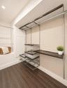 Recessed lighting, wood-finish flooring, built-in shelving system with hanging rods, built-in desk, and wire pull-out drawers