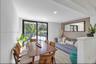 Sliding glass doors, recessed lighting, wood-finish flooring, and a half-wall partition