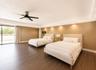 Spacious room featuring wood-finish flooring, recessed lighting, a modern ceiling fan, and sliding glass doors opening to an outdoor area