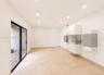 Recessed ceiling lighting, sliding glass door, light-toned floor tile, and built-in wall cabinetry