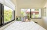 Dual windows with black frames and white window treatments