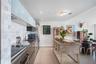 Sleek kitchen featuring a stainless steel appliance suite, mosaic tile backsplash, modern cabinetry, and recessed lighting