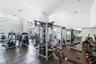 Spacious fitness area featuring rubber tile flooring, recessed lighting, and large windows