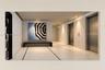 Recessed ceiling lighting, light-toned flooring with dark inlay, and multiple elevator access points