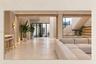 Recessed lighting, light-toned tile flooring, and a floating staircase with integrated lighting