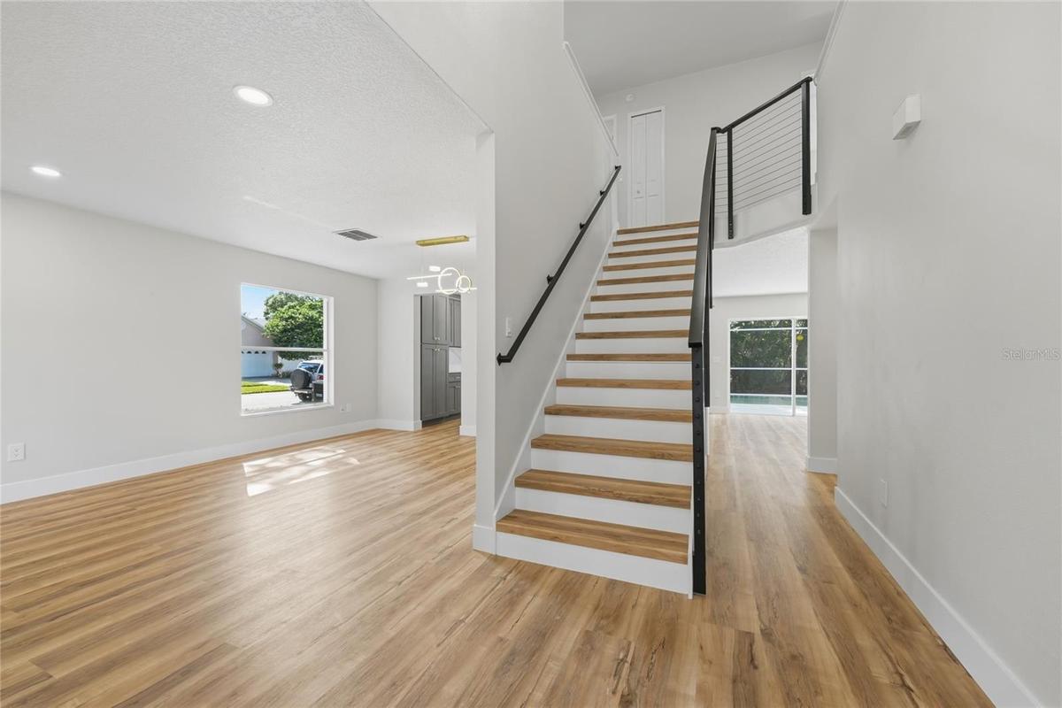Entry way showcasing modern cable stair railing