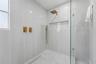 Porcelain tile shower featuring a custom-designed wall niche