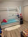 Wood-finish flooring with neutral wall paint and white bi-fold closet doors