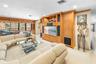 Built-in entertainment center with wood cabinetry, recessed lighting, and wall-to-wall carpeting