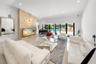 Recessed lighting illuminates a stone-finish accent wall with an integrated display ledge