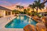 Expansive outdoor area featuring a swimming pool, rock waterfall, and integrated lighting