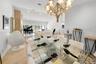 Open-concept living space with tiled flooring, a stone accent wall, and recessed lighting