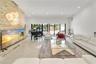 Polished tile flooring, a stacked stone accent wall, recessed lighting, and expansive sliding glass doors