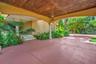 Covered entry with a wood-paneled ceiling and decorative chandelier