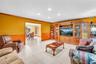 White tile flooring, recessed lighting, and wooden trim