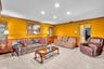 Recessed ceiling lighting, tile flooring, and decorative wood trim