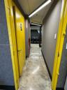 Polished concrete flooring, recessed lighting, and bright yellow door frames