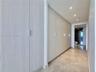 Built-in cabinetry with light wood-finish doors and sleek hardware