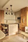 Kitchen with wood-finish cabinetry, integrated refrigerator, and built-in microwave