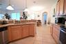 Kitchen featuring light wood-finish cabinetry, stainless steel appliances, and a double basin sink