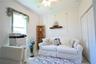 White walls, light-toned flooring, and a ceiling fan