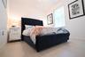 Wood-finish flooring, white walls, and a window with vertical blinds