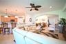 Open-concept living area with tile flooring and recessed lighting