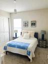 Recessed window with roller shade, crystal pendant light fixture, and textured wall finish