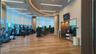 Fitness center featuring wood-finish flooring, full-height windows, and recessed linear lighting