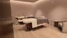 Wood-finish flooring with recessed ceiling lighting, textured wall finishes, and a contemporary light wood door
