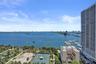 Expansive water frontage with marina access, city skyline, tennis courts, and mature landscaping