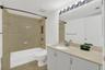 Vanity with an integrated sink, polished chrome faucet, and ample storage cabinetry