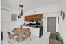 Kitchen with black countertops, stainless steel appliances, and wood-finish cabinetry