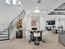 Curved staircase featuring a metal railing, wood-finish flooring, textured metallic wall accent, recessed ceiling lighting, and a built-in circular ba