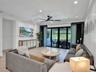 Open-concept interior featuring a central island with a white quartz countertop, matte black faucet, and integrated sink
