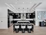 Open-concept living space featuring wood-finish flooring, a coffered ceiling with dark-toned plank inlay, recessed lighting, and a tiered metal chande