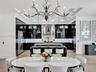 Floor-to-ceiling accent wall featuring textured white tiling, integrated linear fireplace, and custom black built-in shelving