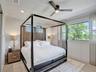 Custom crystal-accented pendant lighting, recessed ceiling fixtures, wood-finish flooring, and expansive window treatments