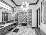 Kitchen featuring a waterfall-edge stone island, high-gloss black cabinetry, wood-finish flooring, recessed ceiling lighting, and suspended pendant fi