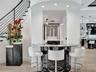Floor-to-ceiling accent wall featuring dimensional stone tile in a linear, staggered pattern with integrated adjustable recessed lighting