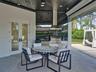 Floating vanity with integrated sinks, floor-to-ceiling mirror, high-gloss cabinetry, multi-pendant lighting, and large-format tile flooring