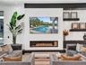 Custom wet bar featuring a curved stone countertop, recessed ceiling lighting, a built-in wall-mounted wine rack, and a curved staircase with black me