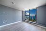 Floor-to-ceiling windows, wood-finish flooring, and expansive water and urban surroundings