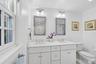 With dual sinks and a shower/tub