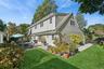 Roses, hydrangeas & mature plantings ensure privacy on this expansive backyard space