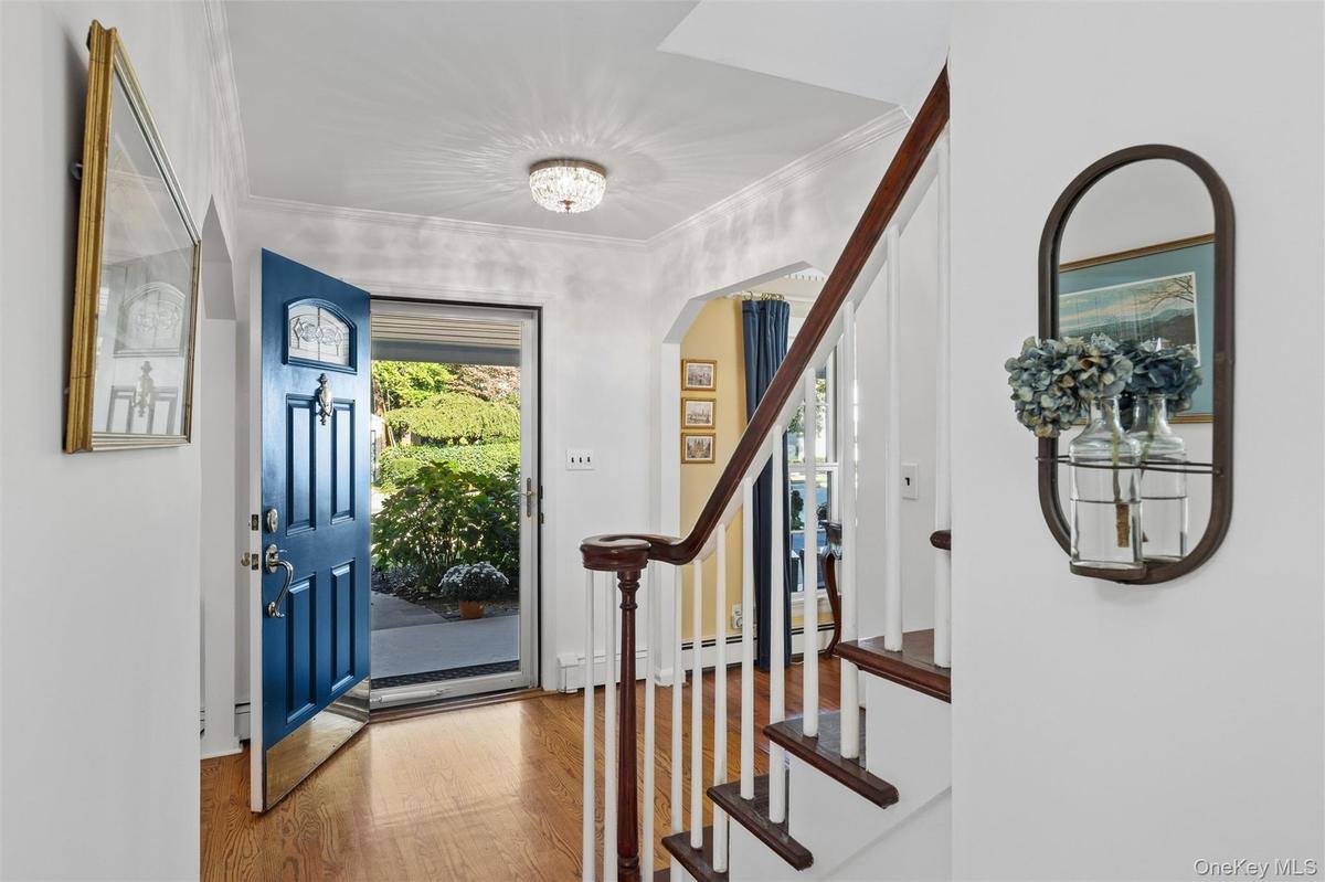 Entry foyer is warmed by hardwood floors & natural light from 2nd floor landing